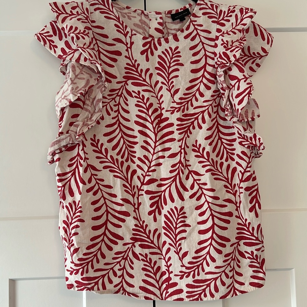 Red and white patterned top with ruffled sleeves